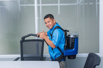 A professional middle-aged janitor making the thumbs up sign while using a backpack vacuum cleaner...