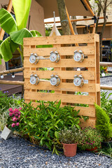 Sculpture of alarm clock hanging on wooden board
