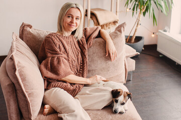 Cut Middle aged Woman sitting on couch at home