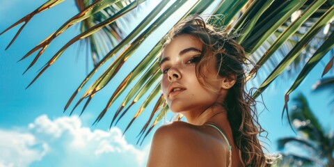portrait of a beautiful girl against a background of tropical plants, palm leaves, spa concept,...
