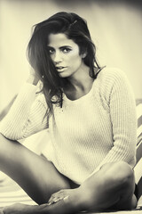 Monochrome, portrait and woman with fashion outdoor to relax on holiday or vacation with style. Cool, girl and sitting with casual clothes in sunshine and confidence in summer at hotel or house