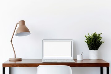 Desk with mockup laptop and minimalistic decor.