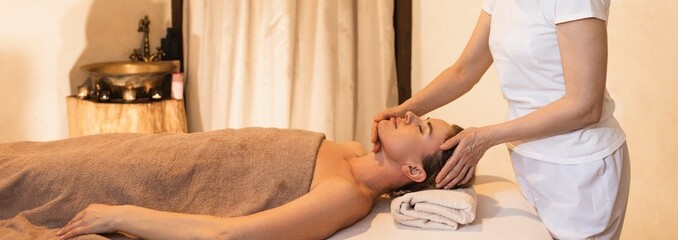 Caucasian woman receives head massage and enjoys relaxing at spa. Anti-stress head massage, close up