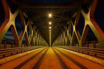 A long exposure of a pedestrian bridge over a river at night. The old bridge. Bratislava, Slovakia....
