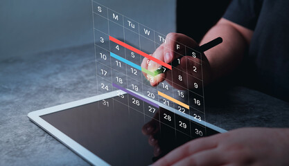Woman use digital tablet to mark dates on virtual hologram calendar. Businesswoman managing her...