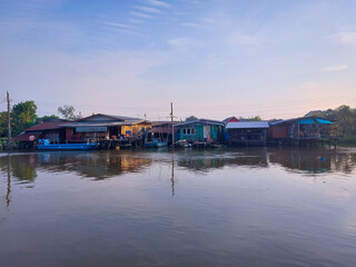 The houses are located along the Bangkok Noi Canal in Nonthaburi province in Thailand.