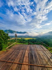 Morning landscape, bright sky, green mountains, and white mist streaking across the mountains....