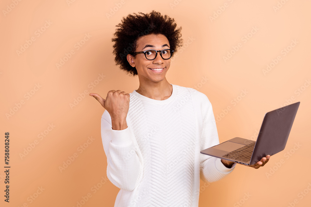 Sticker Photo of satisfied cheerful man wear trendy white jumper recommend buy novelty empty space ad isolated on beige color background