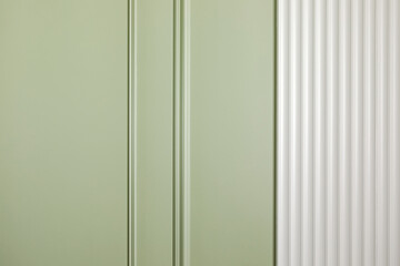 A wall covered with light green paint and molding - 758809251