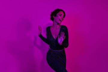Photo portrait of attractive young woman dancing have fun disco wear trendy overall clothes isolated on neon light pink color background