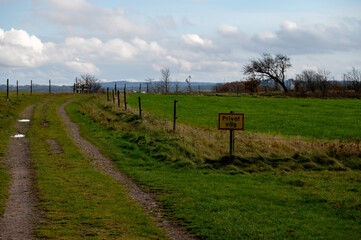 Fototapeta premium Small road with fence and a sign: Private road