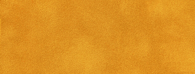 Dark orange background of suede fabric material, closeup. Velvet texture of yellow seamless textile