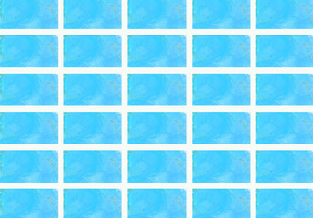Seamless pattern of blue watercolor spots on a white background