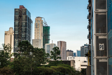 Makati, Philippines - Mar 02, 2024: Luxury condominiums along Washington Sycip Park in Legaspi Village during the late afternoon.