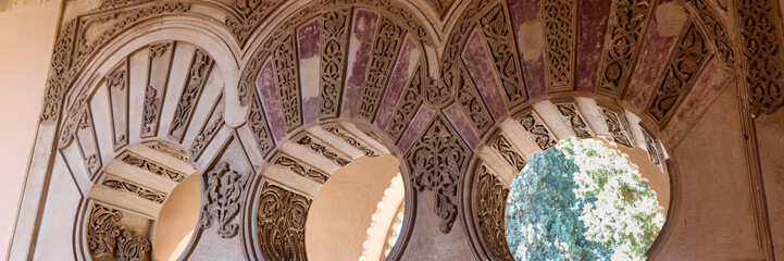 Alcazaba Castle in Malaga, Details of Arabic decorated columns. Costa del Sol, Spain - obrazy, fototapety, plakaty