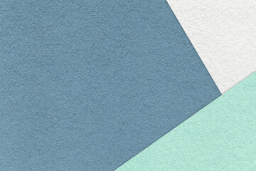 Fototapeta premium Texture of craft blue color paper background with white, green and mint border. Vintage denim cardboard.