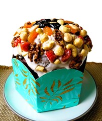 Festive traditional Ukrainian Easter cake on a blue plate on a light background