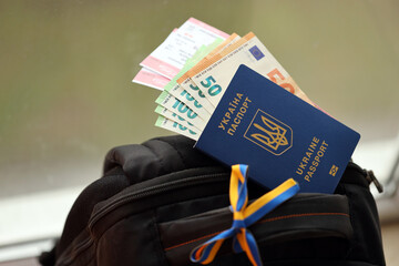 Ukrainian biometrical passport and Euro money with Airlines avia tickets on touristic backpack...