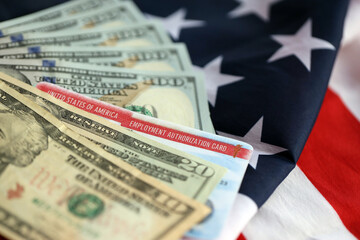 Employment Authorization Card United States of America Work Permit and dollar bills on folded US...