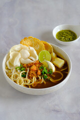 emie, Indonesian noodle with shrimp broth, dry shrimp, , fried onion,onion leaves, bolied potatoes, egg and crackers