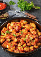 fried spanish potatoes with paprika sauce in bowl