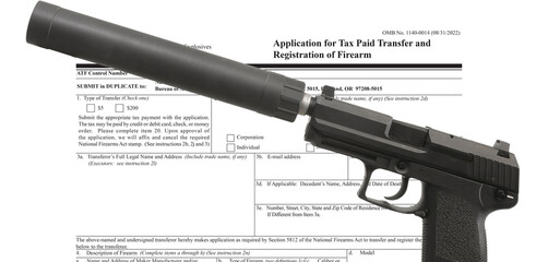 Semi automatic handgun with silencer in front of ATF public domain tax form - obrazy, fototapety, plakaty
