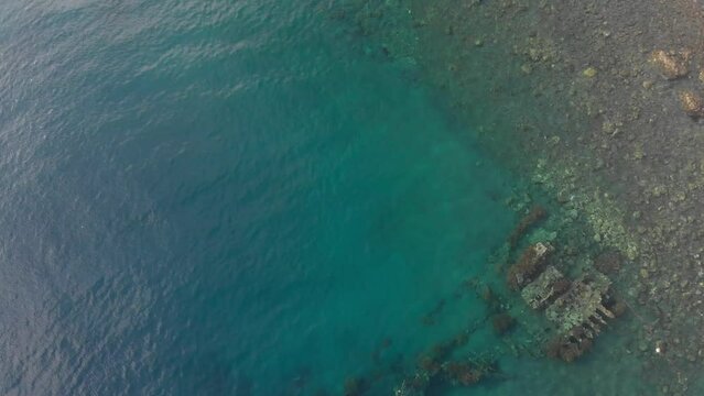 Aerial view of shipwreck in shallow blue water, Amed, Bali, Indonesia