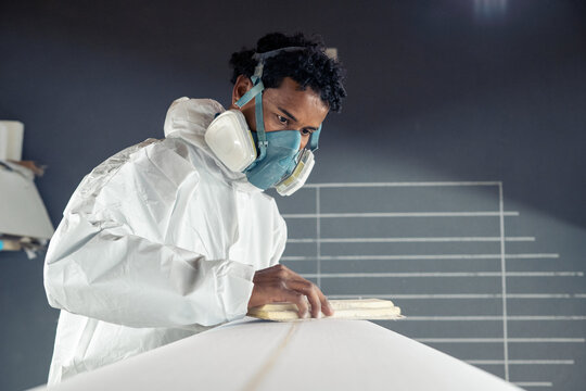 Shaper working on surf board