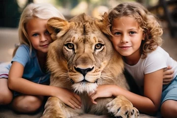 Foto op Canvas Animal Magic: Two Children Playing with a Young Lion © PlanoDigitalArt