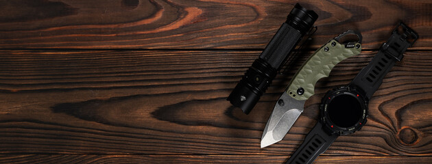 Everyday carry EDC items for men in black color - flashlight, watch and knife. Survival set....