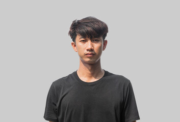 A young Asian man in his 20s wearing black t-shirt is depressed and worried in distress standing on...