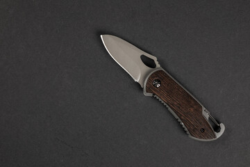 tactical folding knife. EDC knife. on dark background