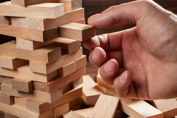 Planning, risk and strategy in business, businessman and engineer gambling placing wooden block on a tower