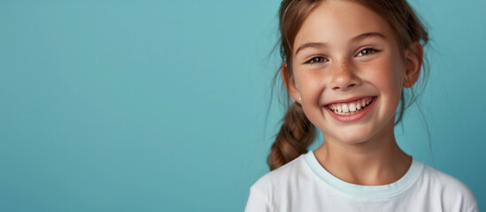 One smiling teeth happy young 10 yr old girl portrait long hair in braid lifestyle education wellness concept campaign isolated on blank blue studio background copy space fun caucasian Australian - Powered by Adobe