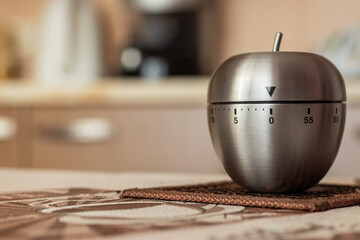Kitchen timer in shape of apple on table. Space for text
