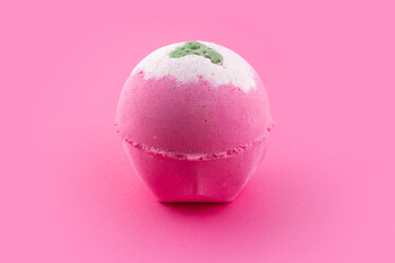 Purple bath bomb on pink background