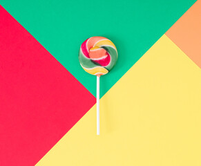 Colorful composition made with red, green, yellow and orange lollipop on red, green, yellow and...