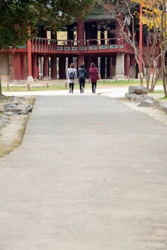 View of the walking female tourist toward to the pavilion