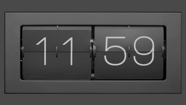 Flip clock quickly flips. Retro flip clock changing from 11:59 to 12:00. Slow motion. Close up. 