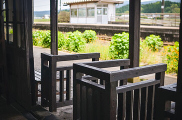 Wooden turnstiles at an old railway station in a Japanese town.