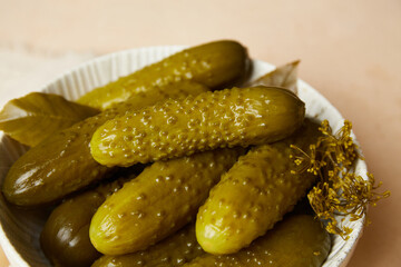 Marinated gherkins in a bowl. Homemade pickles. Close-up 