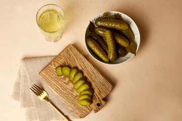 Pickles in a bowl and on a wooden board, cucumber pickle in a glass. Homemade pickled vegetables.....