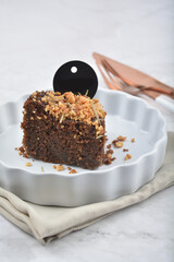 premium freshly baked dark cocoa chocolate brownie gold flower and earl grey peanut round birthday cake with walnut in wood bento box on white marble halal food sweet dessert menu for pastry cafe shop