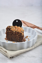 premium freshly baked dark cocoa chocolate brownie gold flower and earl grey peanut round birthday cake with walnut in wood bento box on white marble halal food sweet dessert menu for pastry cafe shop