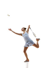 Concentrate young woman, badminton athlete in motion playing isolated over white background. Winning game. Concept of professional sport, active lifestyle, hobby, game