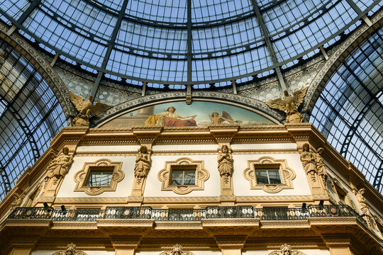 Detail of the iron and glass dome of the Galleria Vittorio Emanuele II (1877) historic shopping gallery, with a mosaic lunette depicting an allegory of Europe, Milan, Lombardy, Italy