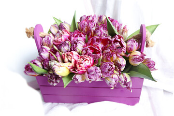 A lilac pink box with peony-shaped tulips.