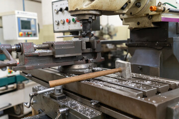 Fototapeta na wymiar Metal working milling machine with a hammer in a workshop