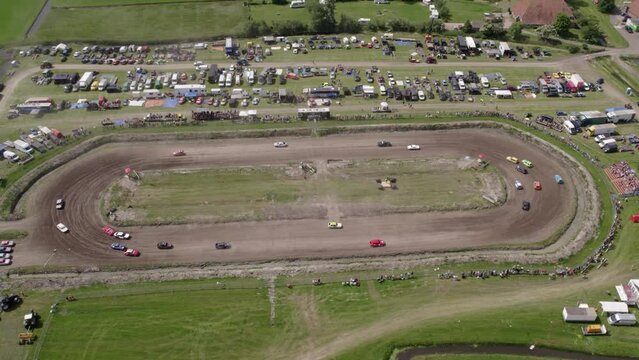 Makkum, Netherlands - 18 June 2022: Aerial view of race with old cars (Autocross) on dirt track, Netherlands