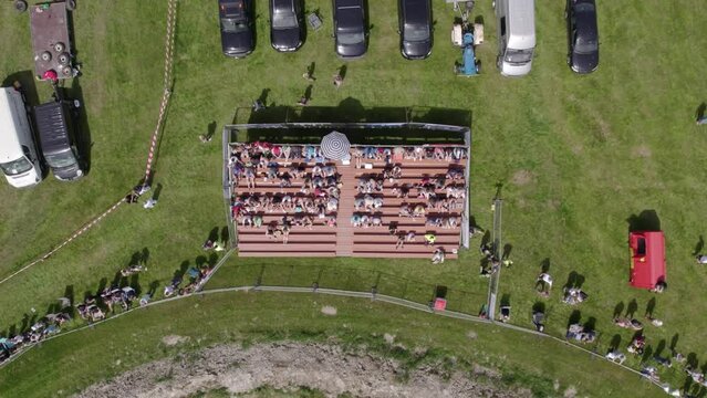 Makkum, Netherlands - 18 June 2022: Aerial view of people watching autocross in meadow, Netherlands